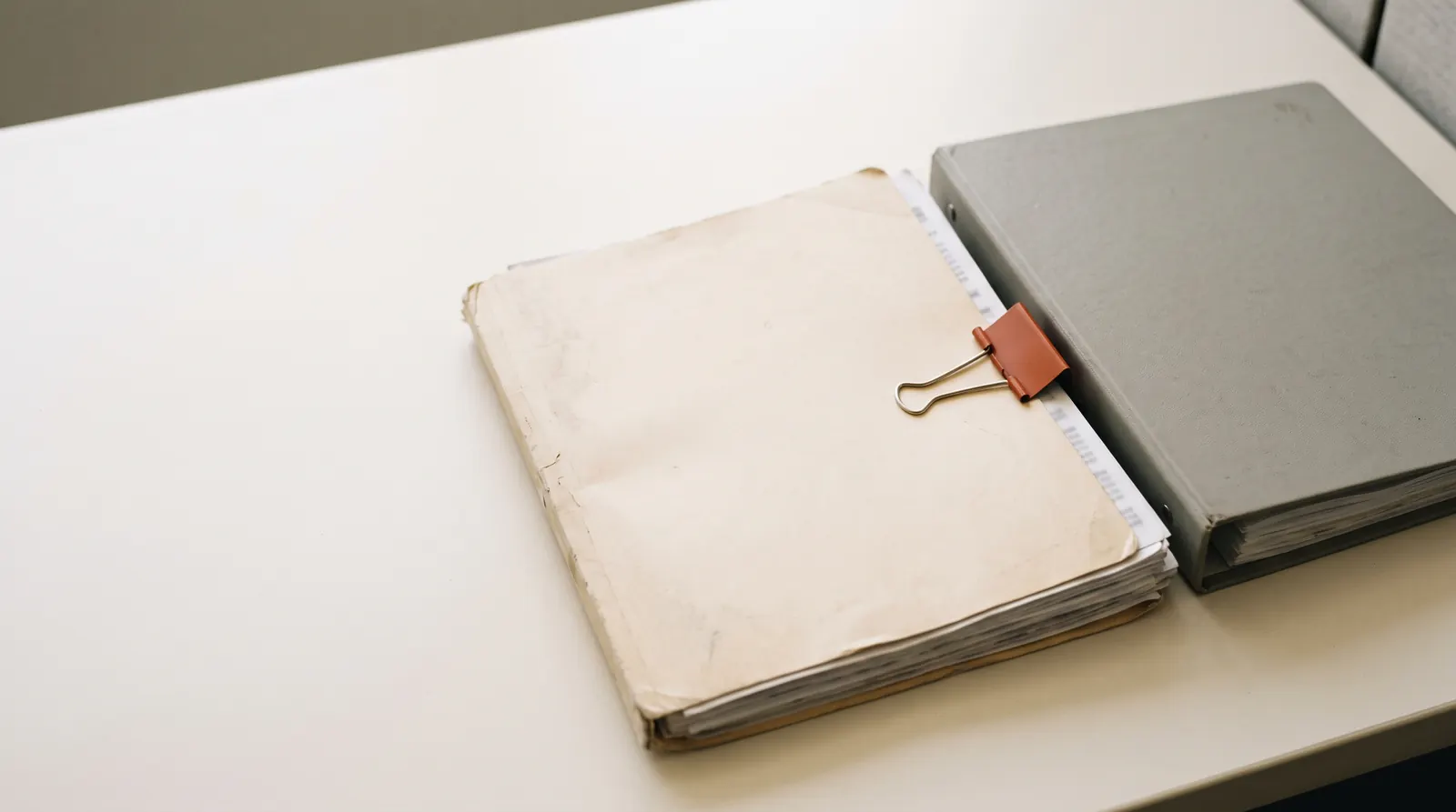 Contractor compliance files, a calculator and expired compliance opinions on a plant office desk